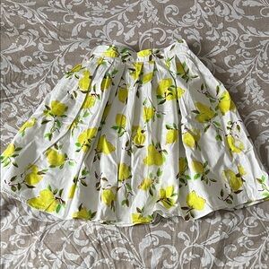 Lemon printed knee length pleated full skirt with pockets